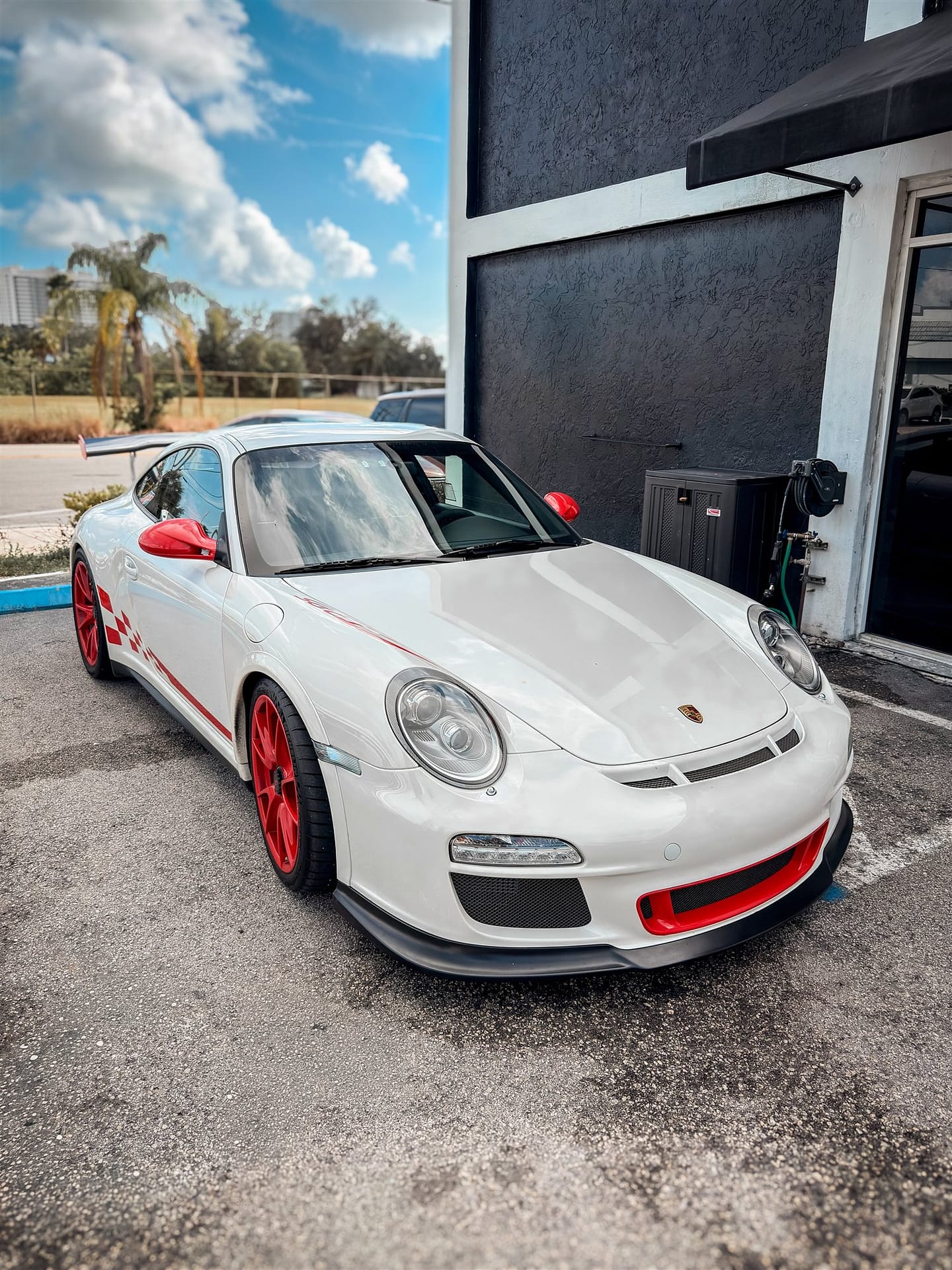 White Porsche 911 GT3 with red wheels and calipers — wheel and caliper ceramic coating in Miami FL
